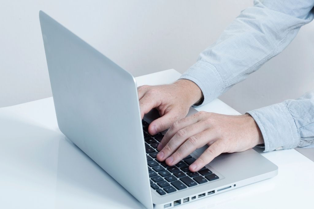 person typing on a laptop
